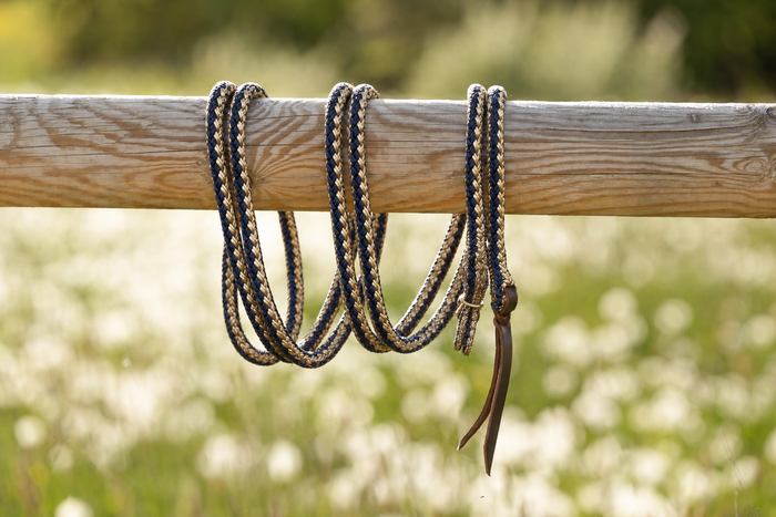 Naturalnavy — Gaucho rope with gold hardware on a wooden beam